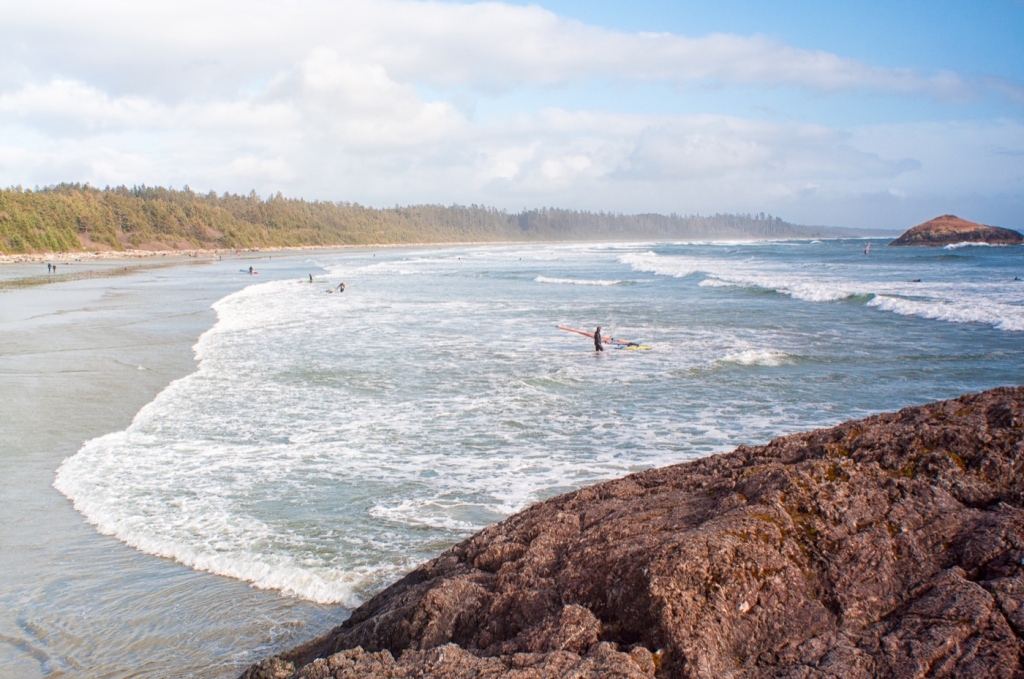 The surfers and the rock formation add elements into this stunning shot of Long Beach.